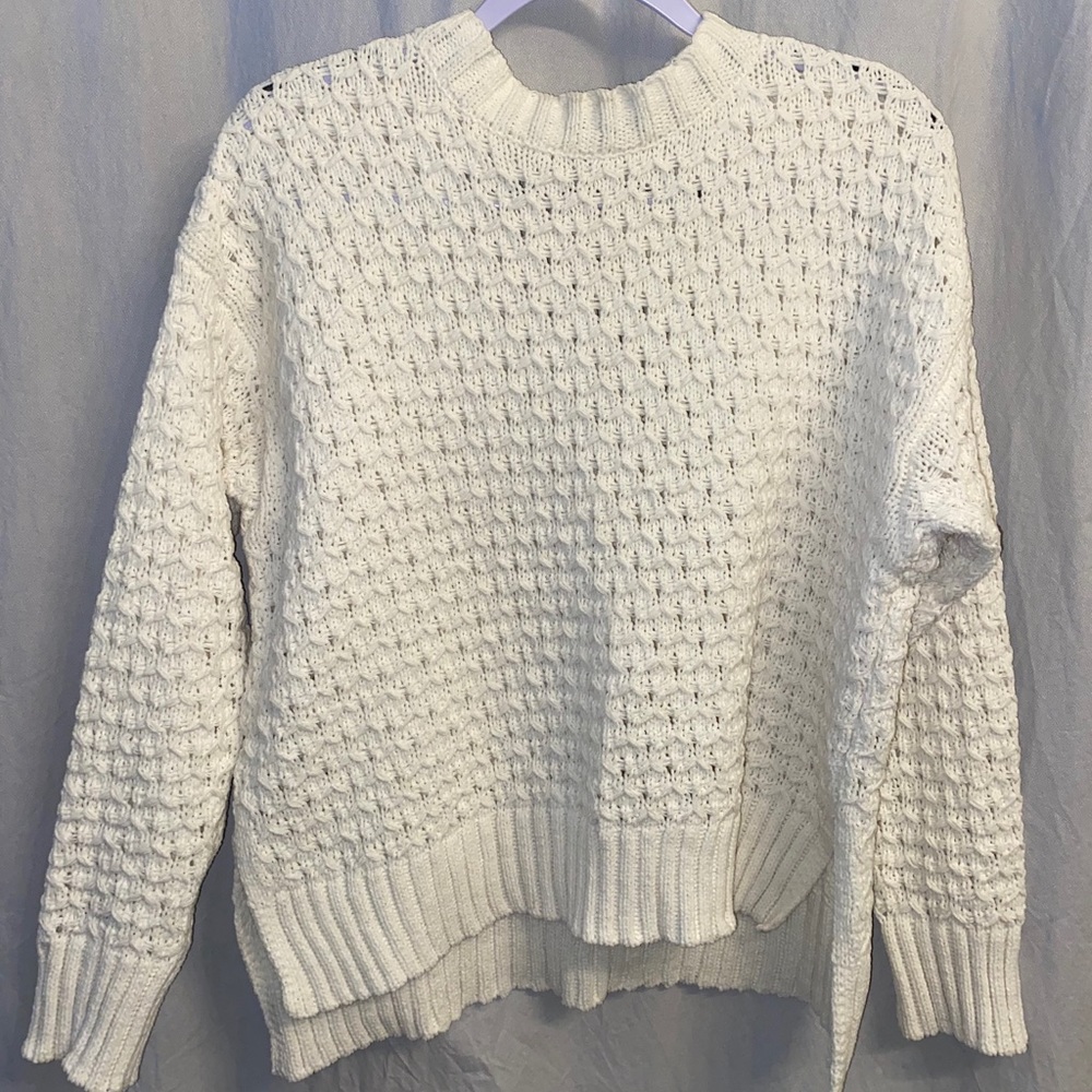 Ivory colored fuzzy sweater.